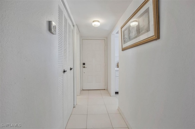 corridor with light tile patterned flooring