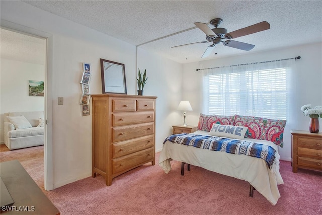 carpeted bedroom featuring a textured ceiling and ceiling fan