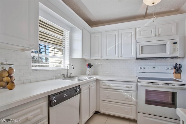 kitchen featuring sink, tasteful backsplash, a textured ceiling, white appliances, and white cabinets