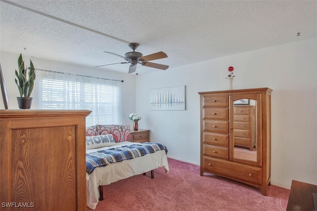 bedroom featuring a textured ceiling, carpet floors, and ceiling fan