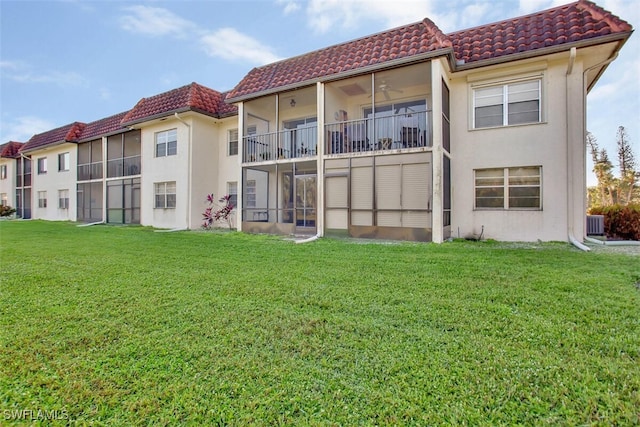 back of house featuring a yard and a balcony