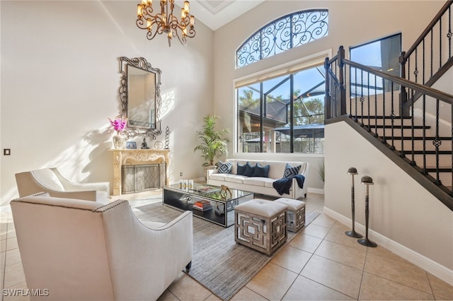 tiled living room featuring a premium fireplace, high vaulted ceiling, and a chandelier