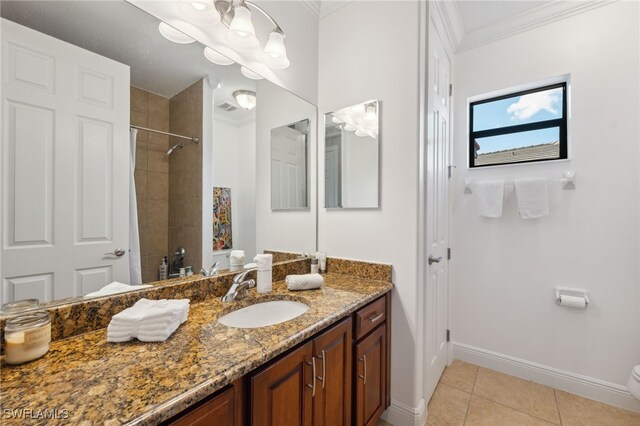 bathroom featuring tile patterned flooring, tiled shower, toilet, vanity, and ornamental molding