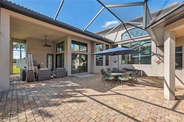 view of patio / terrace featuring a lanai and ceiling fan