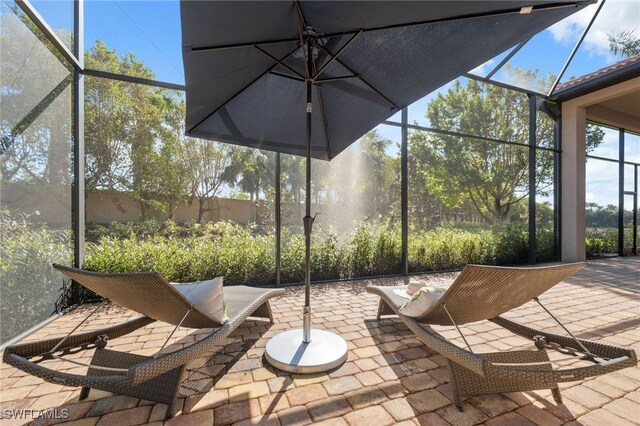 view of patio featuring a lanai