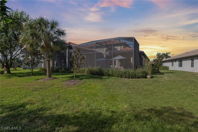 yard at dusk with glass enclosure