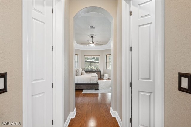 hall featuring hardwood / wood-style flooring and crown molding