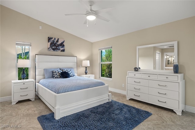 bedroom with lofted ceiling, a ceiling fan, and baseboards