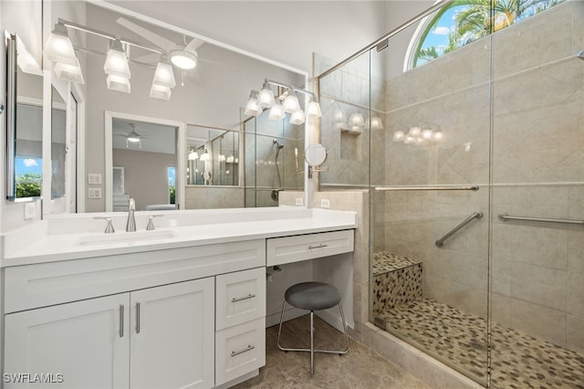 full bath with vanity, a shower stall, and a ceiling fan