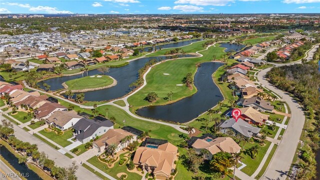 birds eye view of property with view of golf course, a water view, and a residential view