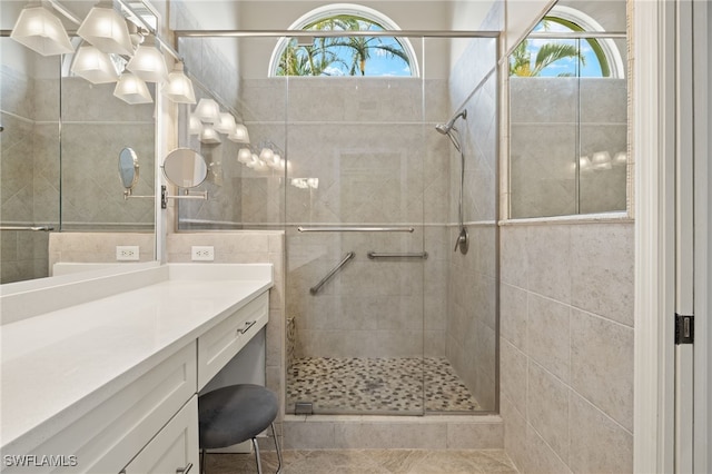 bathroom featuring a stall shower, plenty of natural light, and vanity