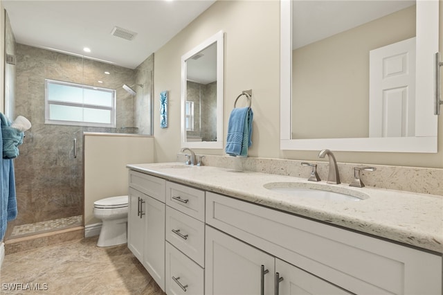 full bathroom with a shower stall, visible vents, and a sink