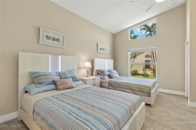 bedroom with a ceiling fan, vaulted ceiling, and baseboards