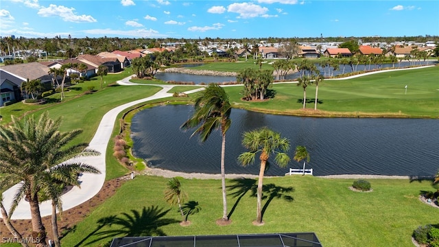 drone / aerial view featuring view of golf course, a water view, and a residential view