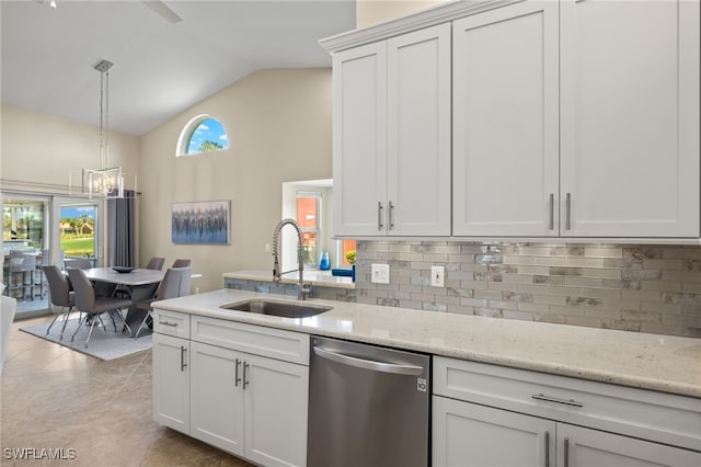 kitchen with a sink, vaulted ceiling, backsplash, dishwasher, and decorative light fixtures