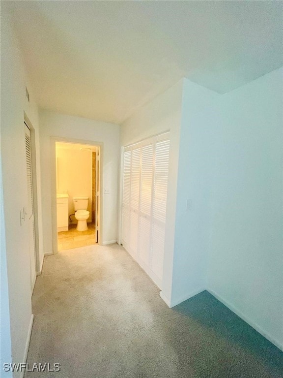 unfurnished bedroom featuring carpet flooring and baseboards