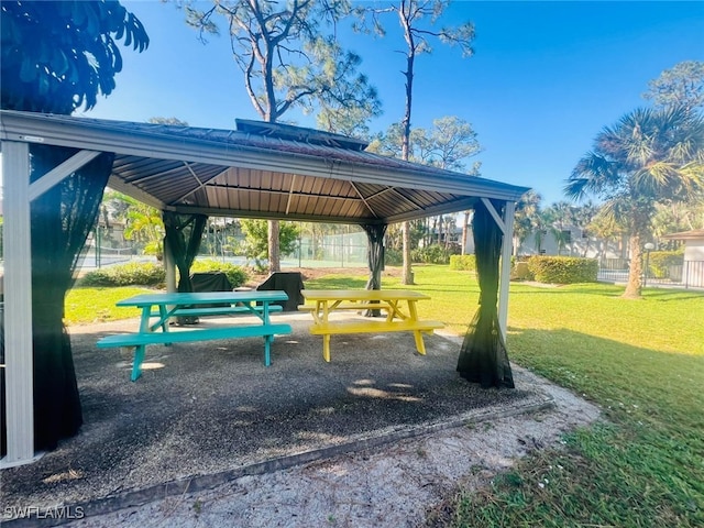 view of property's community with a yard, a gazebo, and fence