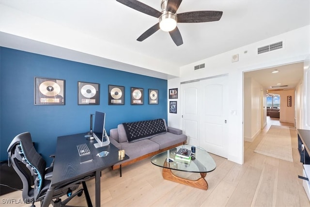 living room with ceiling fan and light hardwood / wood-style floors