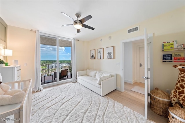 living room with ceiling fan and light hardwood / wood-style floors