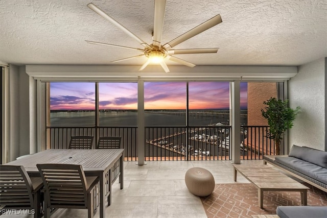 sunroom / solarium featuring ceiling fan