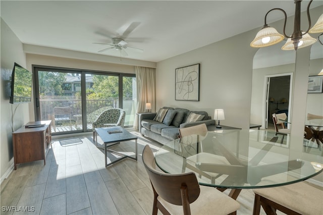 living room featuring light wood-type flooring and ceiling fan