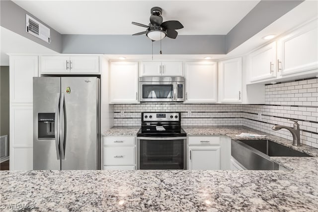 kitchen featuring white cabinets, decorative backsplash, sink, and appliances with stainless steel finishes