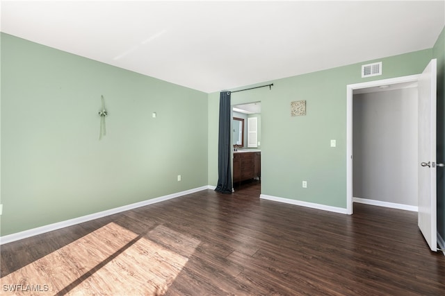 unfurnished bedroom featuring dark hardwood / wood-style floors