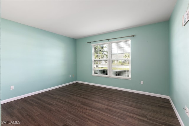 unfurnished room featuring dark hardwood / wood-style flooring