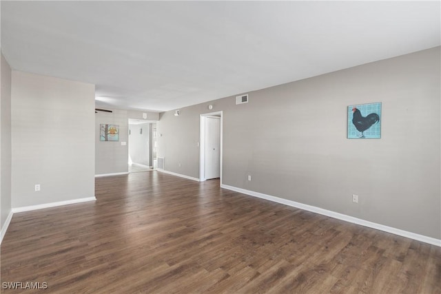 unfurnished room with dark hardwood / wood-style flooring