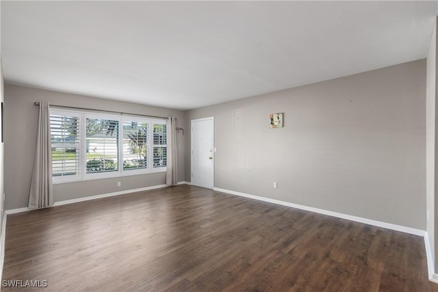 spare room featuring dark hardwood / wood-style floors