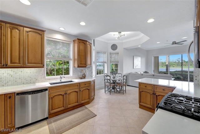 kitchen featuring sink, dishwasher, light tile patterned floors, ceiling fan with notable chandelier, and crown molding