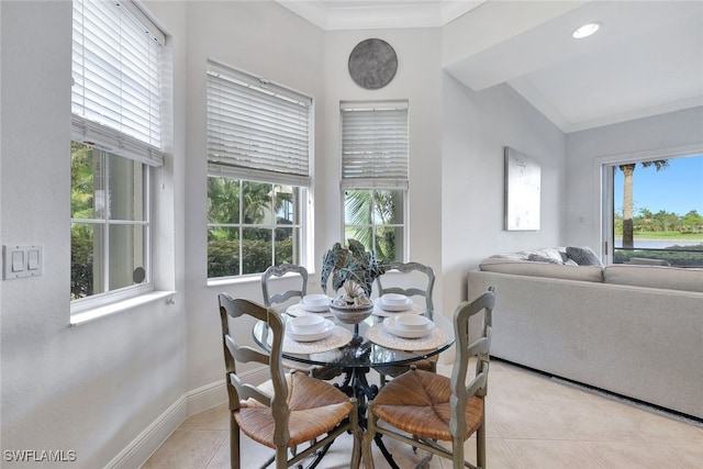 tiled dining space featuring lofted ceiling