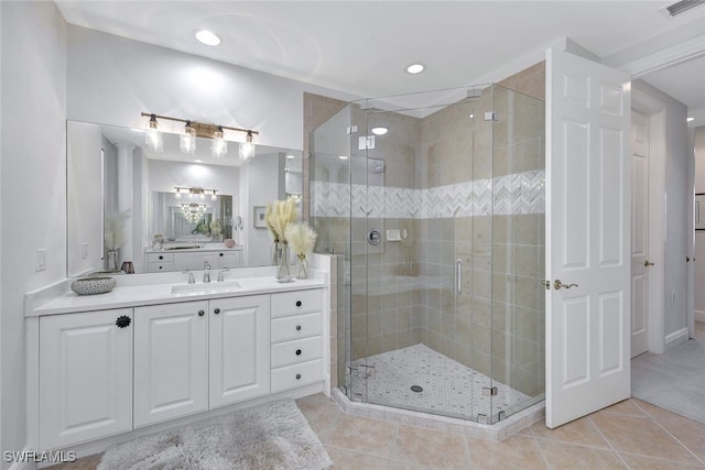 bathroom with vanity, an enclosed shower, and tile patterned floors