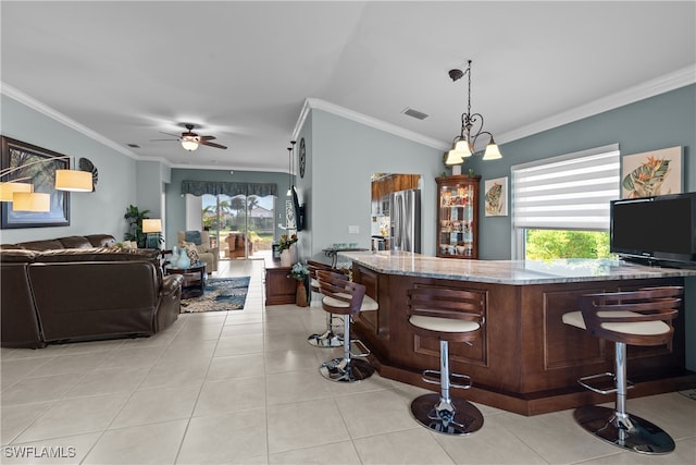 bar with plenty of natural light, stainless steel fridge, light stone counters, and crown molding