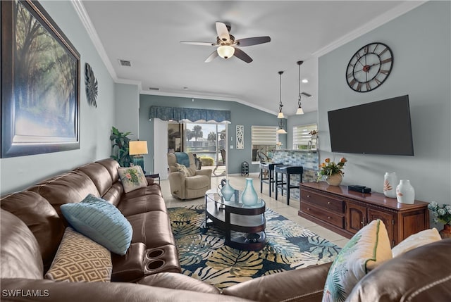 tiled living room with ceiling fan, vaulted ceiling, and ornamental molding