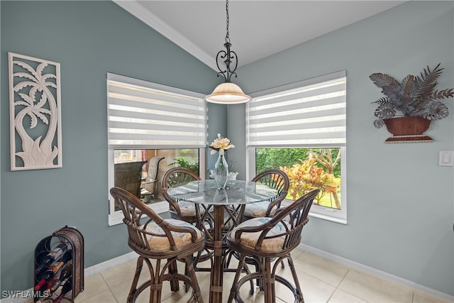 tiled dining area with vaulted ceiling and ornamental molding