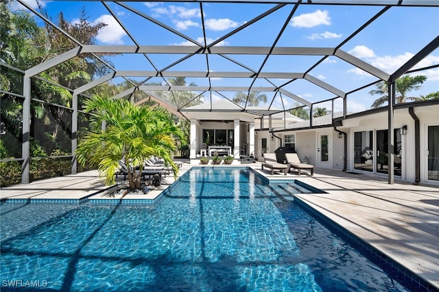 view of swimming pool with glass enclosure and a patio area