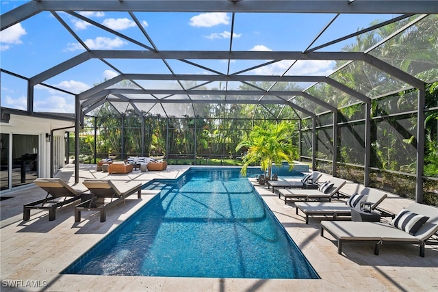 view of swimming pool featuring an outdoor living space, a lanai, and a patio