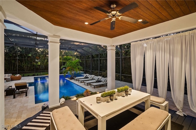 view of pool featuring ceiling fan, a patio area, a lanai, and an outdoor living space