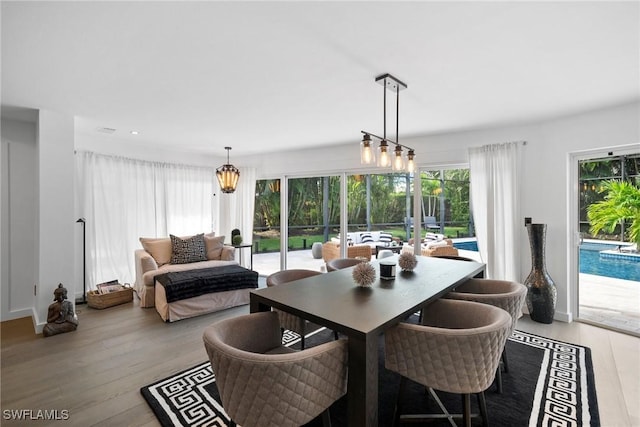 dining area featuring light hardwood / wood-style floors and a chandelier