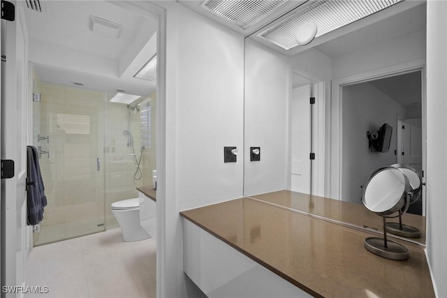 bathroom featuring tile patterned floors, toilet, and walk in shower