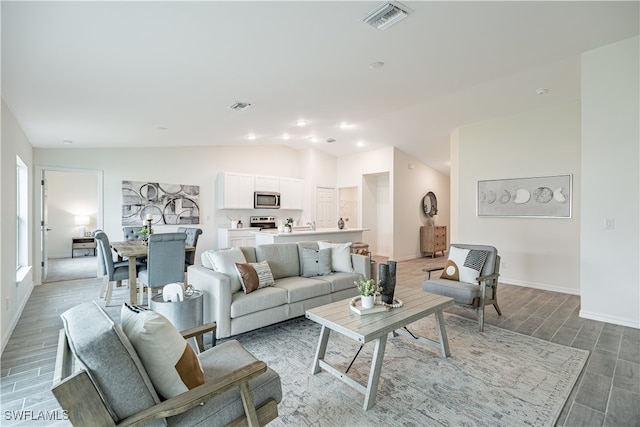 living room featuring hardwood / wood-style floors and vaulted ceiling