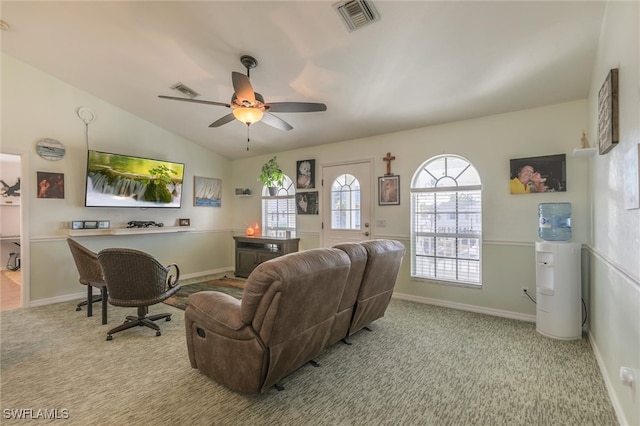 carpeted living room with ceiling fan and vaulted ceiling