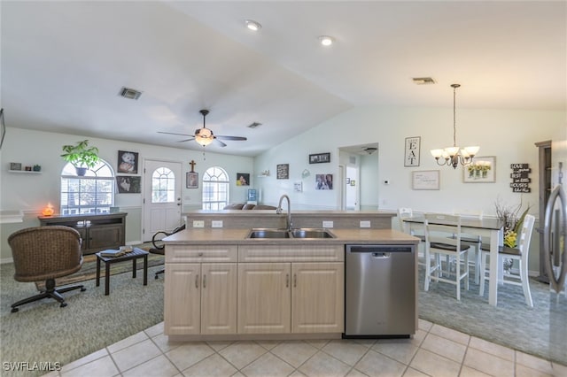 kitchen featuring lofted ceiling, a center island with sink, sink, stainless steel dishwasher, and decorative light fixtures