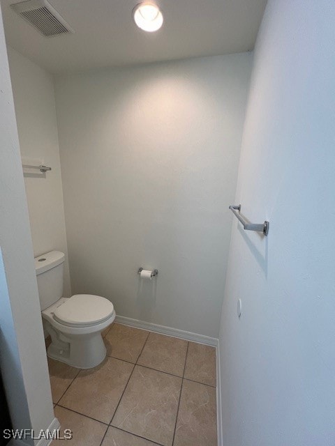 bathroom featuring toilet and tile patterned flooring