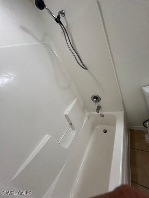 bathroom with toilet and shower / bathing tub combination