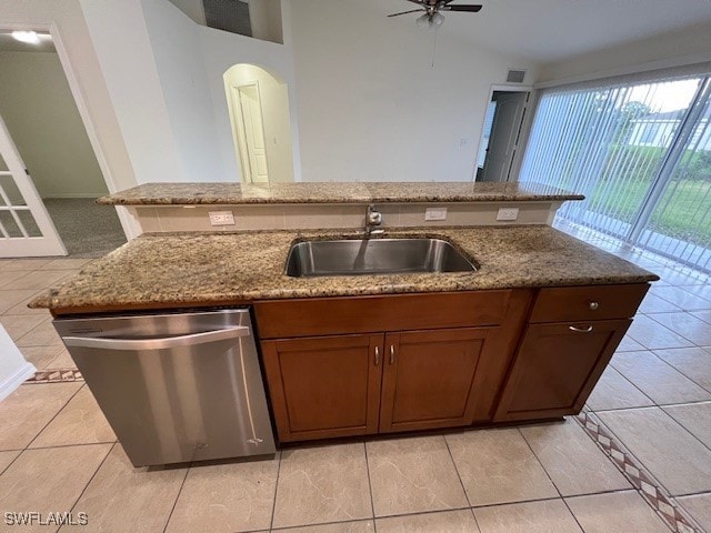 kitchen with sink, light stone countertops, ceiling fan, light tile patterned floors, and dishwasher