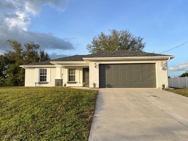 ranch-style home featuring a garage and a front lawn