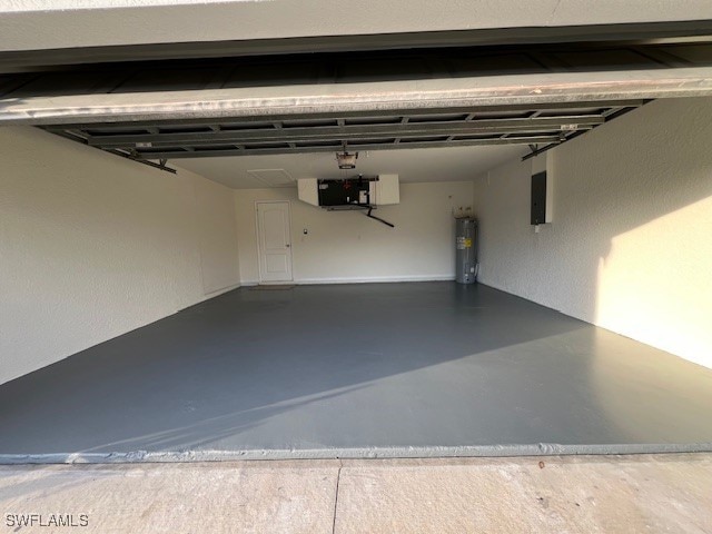 garage with electric panel and strapped water heater