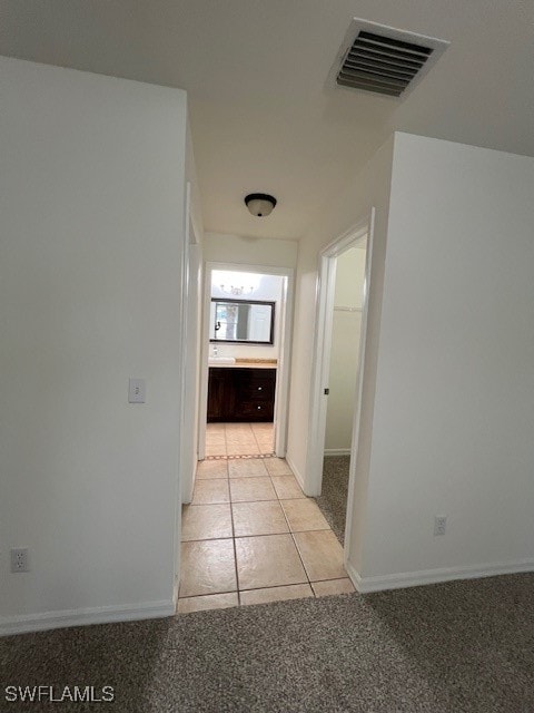 hall featuring light tile patterned flooring